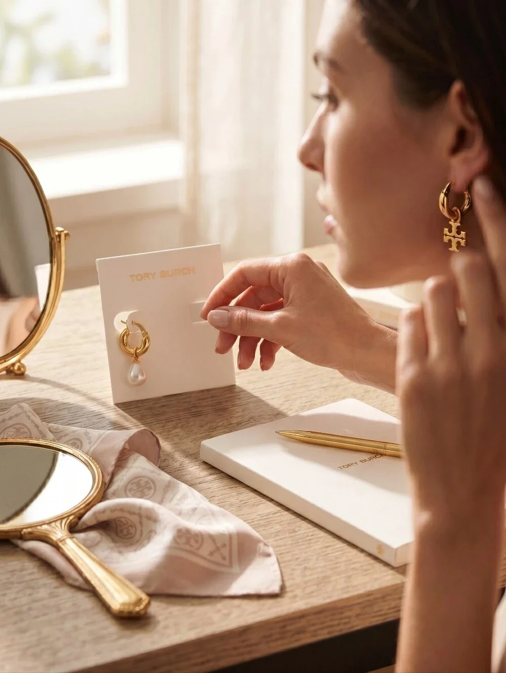 Tory Burch Asymmetrical Gold Hoop Earrings with Pearl Drop and Logo Charm